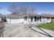 Charming single-story home with an attached garage and a well-manicured lawn at 4623 Clark St, Anderson, IN 46013