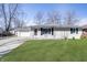 Charming single-story home with a well-maintained lawn and attached garage at 4623 Clark St, Anderson, IN 46013