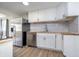 Stylish kitchen featuring modern appliances, white cabinetry, and butcher block countertops at 4623 Clark St, Anderson, IN 46013