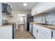 Galley kitchen featuring stainless steel appliances, butcher block countertops, and mosaic backsplash at 4623 Clark St, Anderson, IN 46013