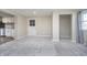 This carpeted living room features neutral walls and access to the kitchen at 4623 Clark St, Anderson, IN 46013