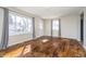 Sunlit living room boasts hardwood floors, neutral walls, and two bright windows at 4623 Clark St, Anderson, IN 46013