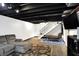 Spacious basement includes a comfy sectional, hardwood floors, and fitness equipment at 4783 Briarwood Trce, Carmel, IN 46033