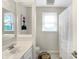 Well-lit bathroom with a single sink, mirror, and a shower with a curtain at 4783 Briarwood Trce, Carmel, IN 46033