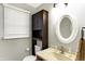 A bathroom with a granite counter, traditional mirror, blinds, and a dark wood cabinet at 4783 Briarwood Trce, Carmel, IN 46033