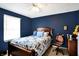 Comfortable bedroom with wood furniture, bright window, and blue accents for a calming feel at 4783 Briarwood Trce, Carmel, IN 46033