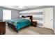 Cozy bedroom features a striped accent wall, ceiling fan, and a comfortable bed with side tables at 4783 Briarwood Trce, Carmel, IN 46033