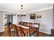 A dining room with a dark wood table set for eight under a chandelier at 4783 Briarwood Trce, Carmel, IN 46033