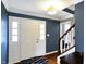 Inviting foyer with hardwood floors, white trim, and a staircase, creating a welcoming entrance at 4783 Briarwood Trce, Carmel, IN 46033