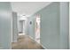 Neutral hallway that leads to a bathroom with a view of the white vanity at 4783 Briarwood Trce, Carmel, IN 46033