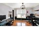 A home office with two desks, hardwood floors and a chandelier-style light fixture at 4783 Briarwood Trce, Carmel, IN 46033