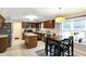 Eat-in kitchen features stainless steel appliances, a breakfast nook with seating, and natural light at 4783 Briarwood Trce, Carmel, IN 46033