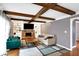 The living room features exposed beams, fireplace, shelves and a large window at 4783 Briarwood Trce, Carmel, IN 46033