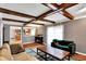 The living room has exposed ceiling beams and a pass-through to the kitchen at 4783 Briarwood Trce, Carmel, IN 46033
