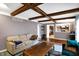The living room has an exposed ceiling beam and an open pass-through to the kitchen at 4783 Briarwood Trce, Carmel, IN 46033