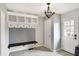 Inviting mudroom featuring a built-in bench with storage and coat hooks, and tile flooring at 4783 Briarwood Trce, Carmel, IN 46033