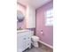 Charming bathroom with a modern vanity, round mirror and lavendar colored walls at 4836 W 71St St, Indianapolis, IN 46268