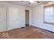 The bedroom features hardwood floors and a window with woven shades at 4836 W 71St St, Indianapolis, IN 46268