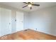 Bright bedroom with hardwood floors, neutral paint, a ceiling fan, and two closets at 4836 W 71St St, Indianapolis, IN 46268