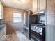 The kitchen features updated stainless steel appliances and decorative tile backsplash at 4836 W 71St St, Indianapolis, IN 46268
