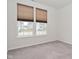 A bright bedroom features two windows with modern blinds and neutral carpeting at 5176 Green Valley Ln, Noblesville, IN 46062