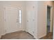 A bright foyer with wood flooring and a view through to a carpeted room at 5176 Green Valley Ln, Noblesville, IN 46062
