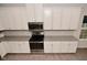 Kitchen features stainless oven and microwave, granite countertops, white cabinets, and herringbone backsplash at 5176 Green Valley Ln, Noblesville, IN 46062