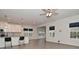 Bright, open-concept living space featuring a kitchen island, modern flooring, and ample sunlight at 5176 Green Valley Ln, Noblesville, IN 46062