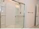 Glass enclosed shower with a built-in seat and mounted shower head at 5176 Green Valley Ln, Noblesville, IN 46062
