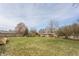 Expansive backyard featuring a well-maintained lawn and mature trees, perfect for outdoor activities and relaxation at 5210 Ashbourne Ln, Indianapolis, IN 46226