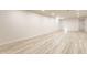 Open basement space with luxury vinyl plank flooring and recessed lighting at 5210 Ashbourne Ln, Indianapolis, IN 46226