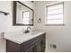 Bathroom with modern sink, new mirror, and freshly painted bright white walls at 5210 Ashbourne Ln, Indianapolis, IN 46226