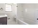 Bathroom featuring a white tub shower and updated window at 5210 Ashbourne Ln, Indianapolis, IN 46226