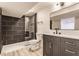 Bathroom with tiled shower, modern vanity, and stylish fixtures at 5210 Ashbourne Ln, Indianapolis, IN 46226