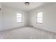 A bedroom with two windows and light gray walls at 5210 Ashbourne Ln, Indianapolis, IN 46226