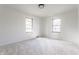 A bedroom with two windows and light gray walls at 5210 Ashbourne Ln, Indianapolis, IN 46226