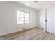 An empty bedroom with a window, closet, and light gray walls at 5210 Ashbourne Ln, Indianapolis, IN 46226