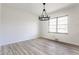 Dining room with modern chandelier and light vinyl floors at 5210 Ashbourne Ln, Indianapolis, IN 46226