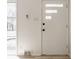 The bright white front door has privacy glass and modern hardware at 5210 Ashbourne Ln, Indianapolis, IN 46226