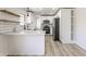 A bright kitchen showcasing white cabinetry, stainless steel appliances, quartz countertops, and modern finishes at 5210 Ashbourne Ln, Indianapolis, IN 46226