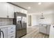 A bright kitchen showcasing white cabinetry, stainless steel appliances, quartz countertops, and modern finishes at 5210 Ashbourne Ln, Indianapolis, IN 46226