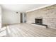 Large bright living room with vinyl floors, a stone fireplace, and a bright sunny window at 5210 Ashbourne Ln, Indianapolis, IN 46226
