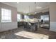 Modern kitchen featuring stainless steel appliances, a large island with seating, and stylish gray cabinetry at 5546 Tart Blvd, Indianapolis, IN 46239