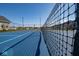View of community tennis courts, framed by a net and showcasing neighborhood homes in the background at 5546 Tart Blvd, Indianapolis, IN 46239