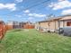 Large backyard with a trampoline, fire pit, a play house and wood fence at 606 Memorial Dr, Beech Grove, IN 46107