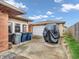 View of the backyard with a detached garage, utility cans, and covered car at 606 Memorial Dr, Beech Grove, IN 46107
