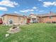 A spacious backyard with a well-maintained lawn, fire pit, and mature trees at 606 Memorial Dr, Beech Grove, IN 46107