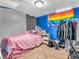 Finished basement bedroom featuring painted walls, carpet, a bed, and colorful decorations at 606 Memorial Dr, Beech Grove, IN 46107