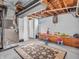 A finished basement with open ceiling with painted walls, and space for recreation and storage at 606 Memorial Dr, Beech Grove, IN 46107