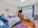 Bright bedroom features hardwood floors, natural light and comfortable furnishings at 606 Memorial Dr, Beech Grove, IN 46107